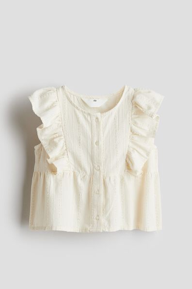 Sleeveless flounced blouse