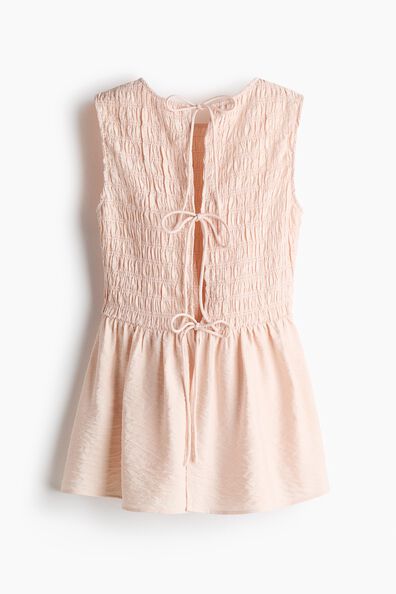 Smocked tie-back peplum top